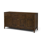 Angled view of solid mango wood sideboard in Antique Brown with four drawers, four doors and tapered legs.