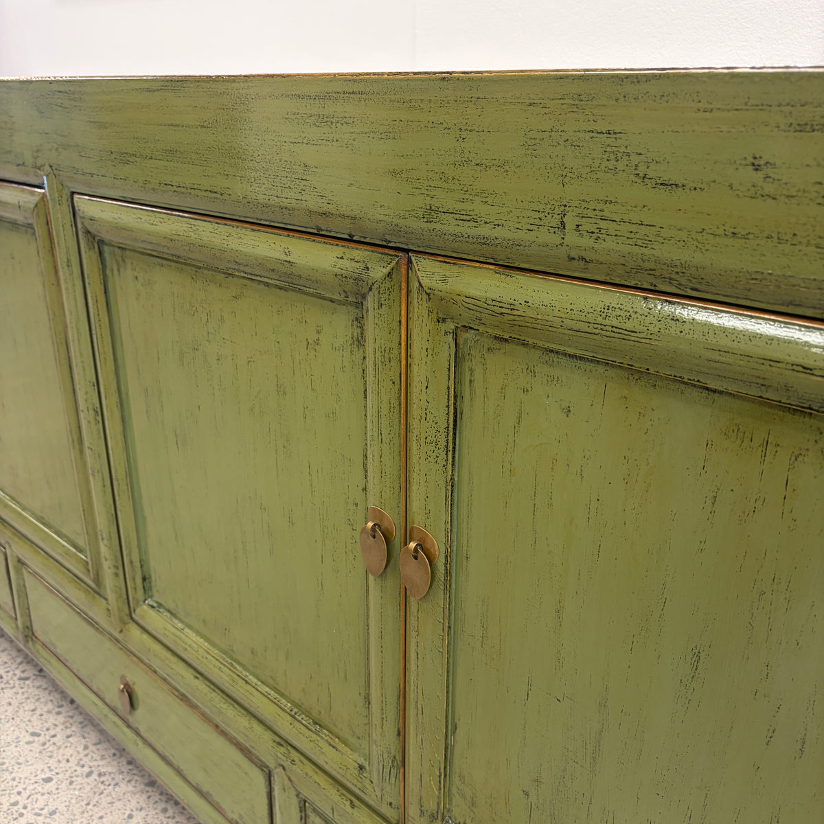 Close-up of Margot Sideboard in Olive showing distressed finish and brass hardware