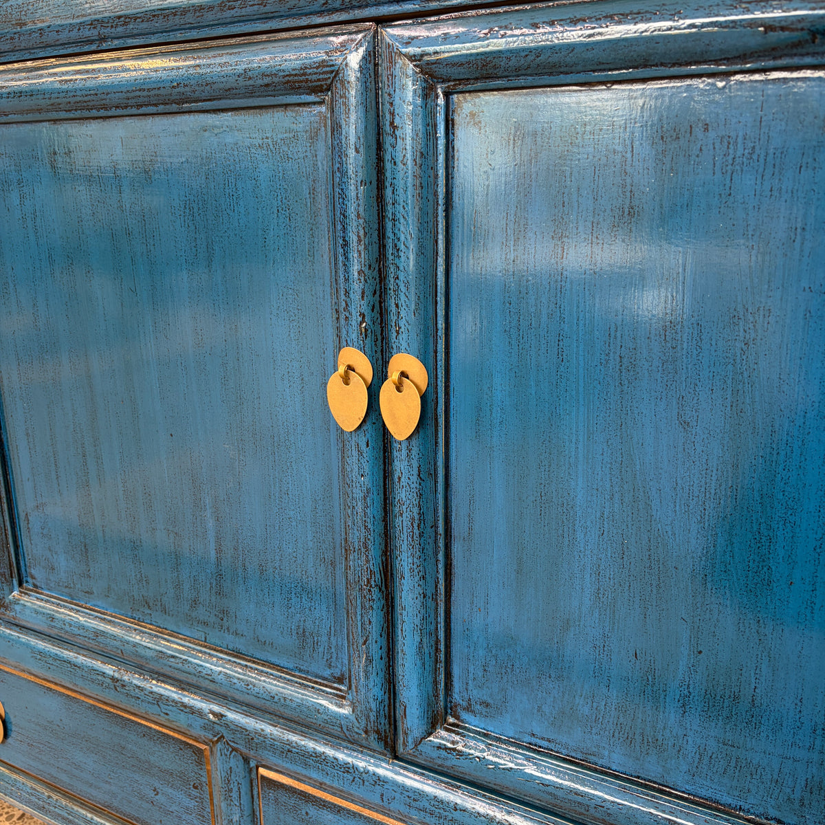 Close-up of Margot Sideboard in Prussian Blue showing brass-toned ring handles and distressed panelled doors