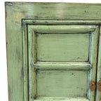 Close-up of the distressed spring green finish and panel detailing on the Maria Sideboard