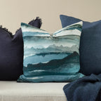 Mariella Cushion styled on a neutral sofa with blue cushions and throw