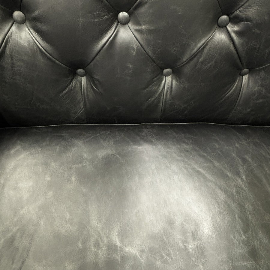 Close-up of the Maxwell Chesterfield sofa's black leather seat and back cushions, highlighting the premium leather and quality craftsmanship.