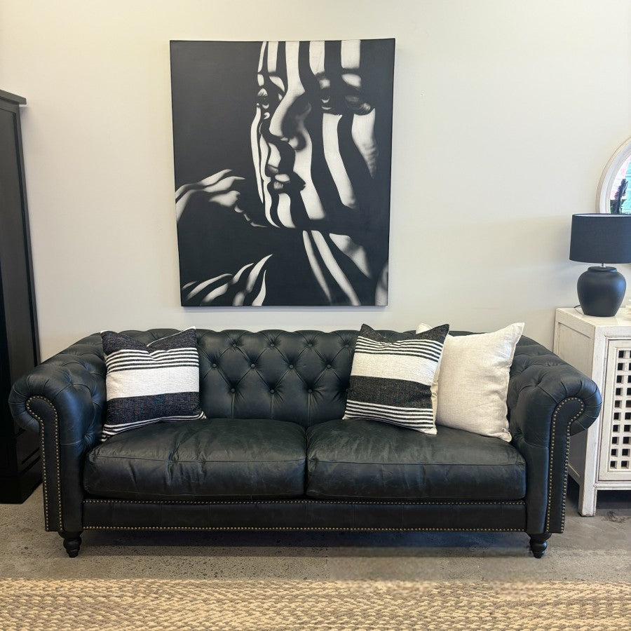 Maxwell Chesterfield sofa in black leather styled in a contemporary living room.