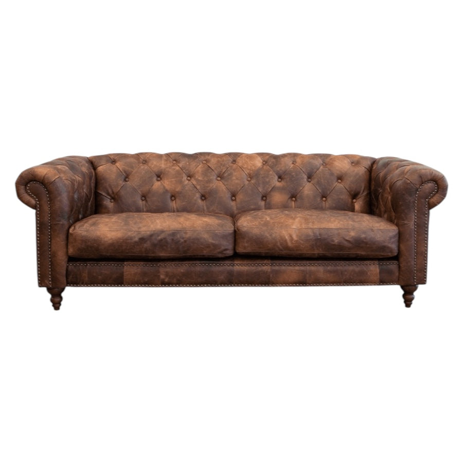 Maxwell Chesterfield sofa in brown leather styled in a contemporary living room.
