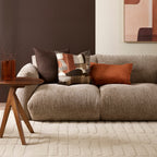 Milano Cushion in Cocoa styled on a neutral sofa with warm earthy cushions