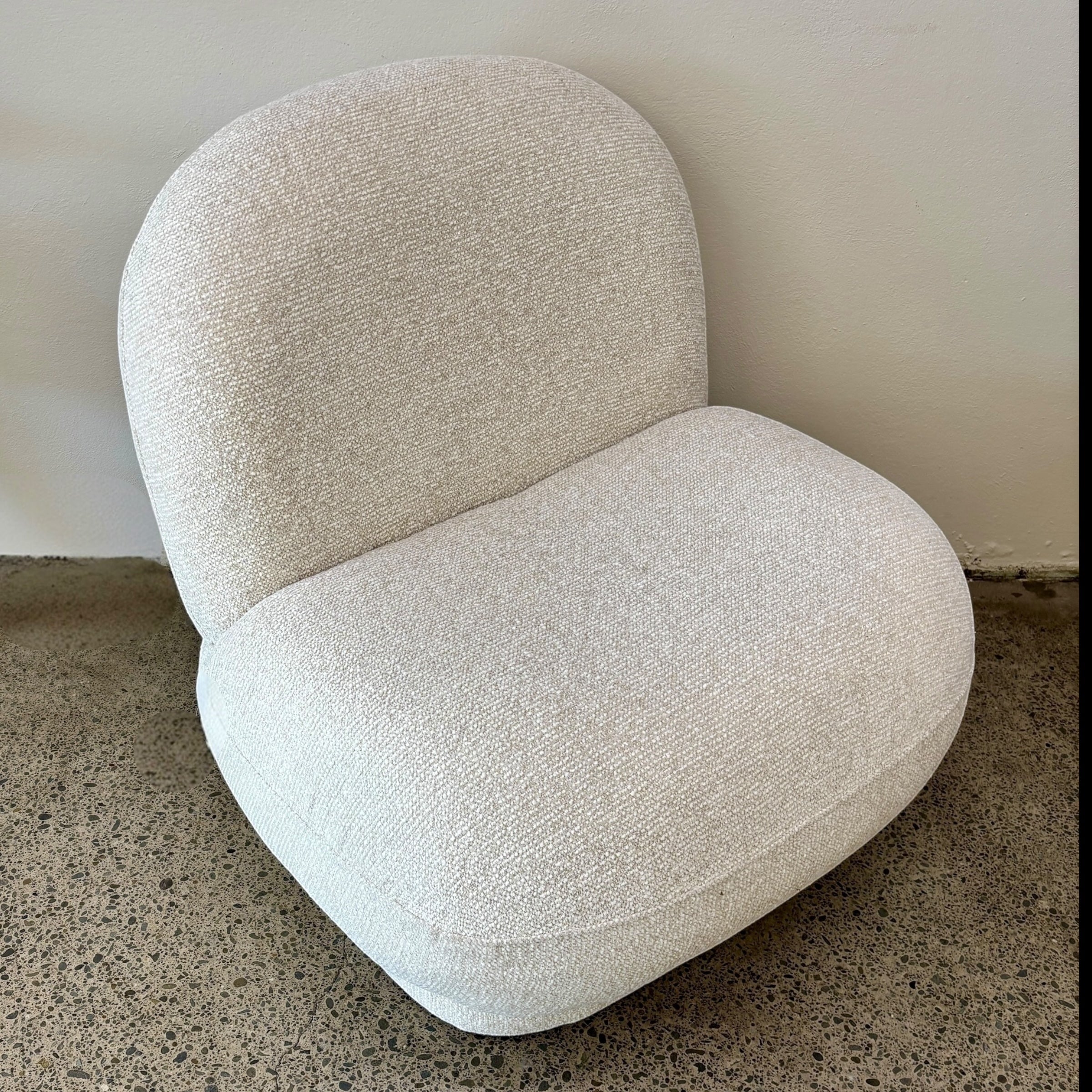 Side profile of the Milo Swivel Chair in Salt, showcasing its rounded silhouette and generously cushioned seat.