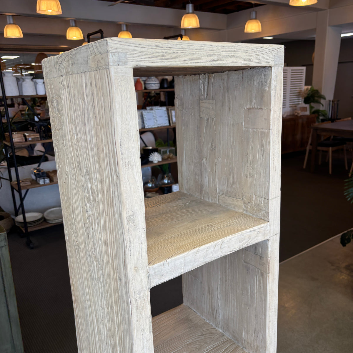 Wooden display cabinet in a room with shelves and lights