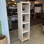 Tall wooden bookshelf in a room with decor elements