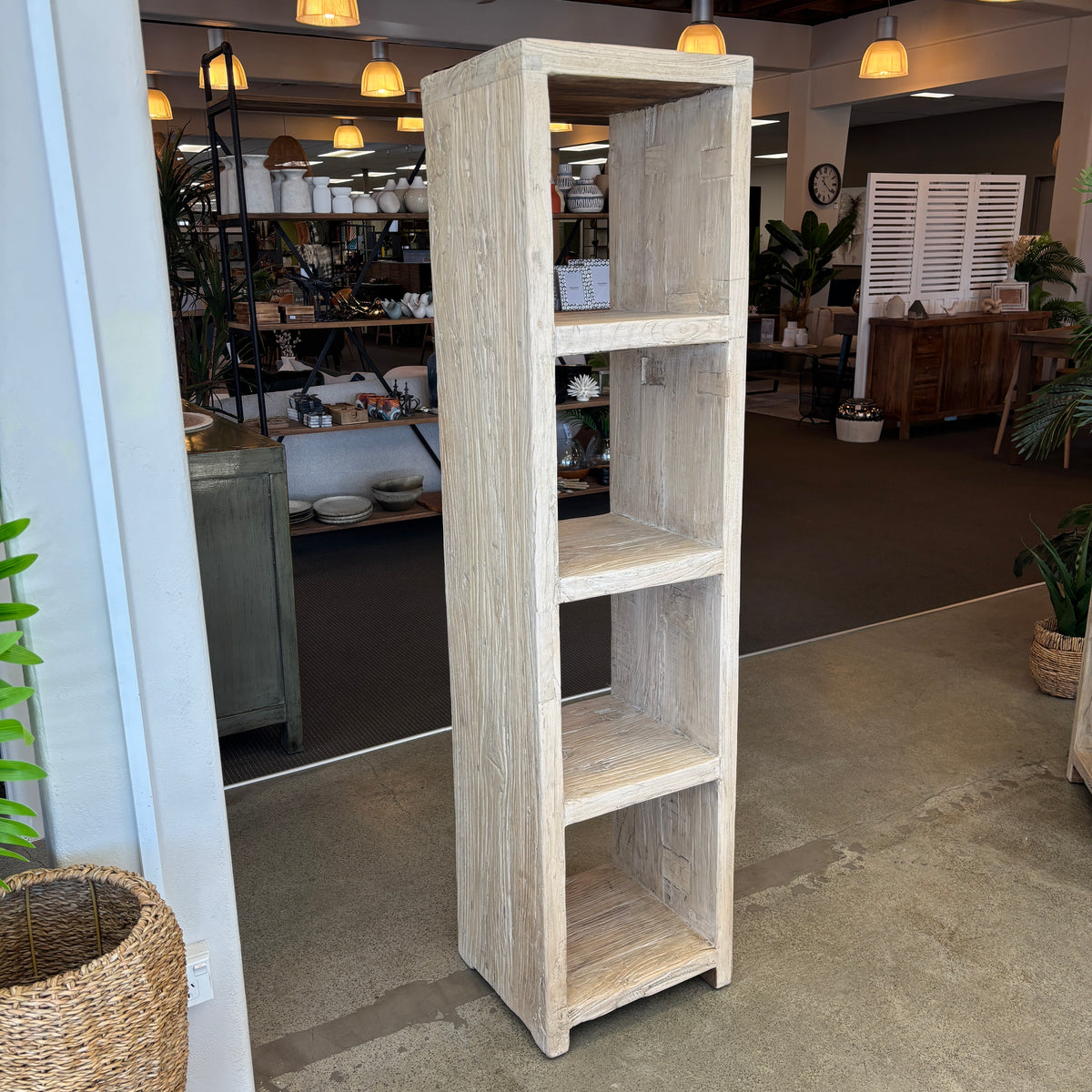 Tall wooden bookshelf in a room with decor elements