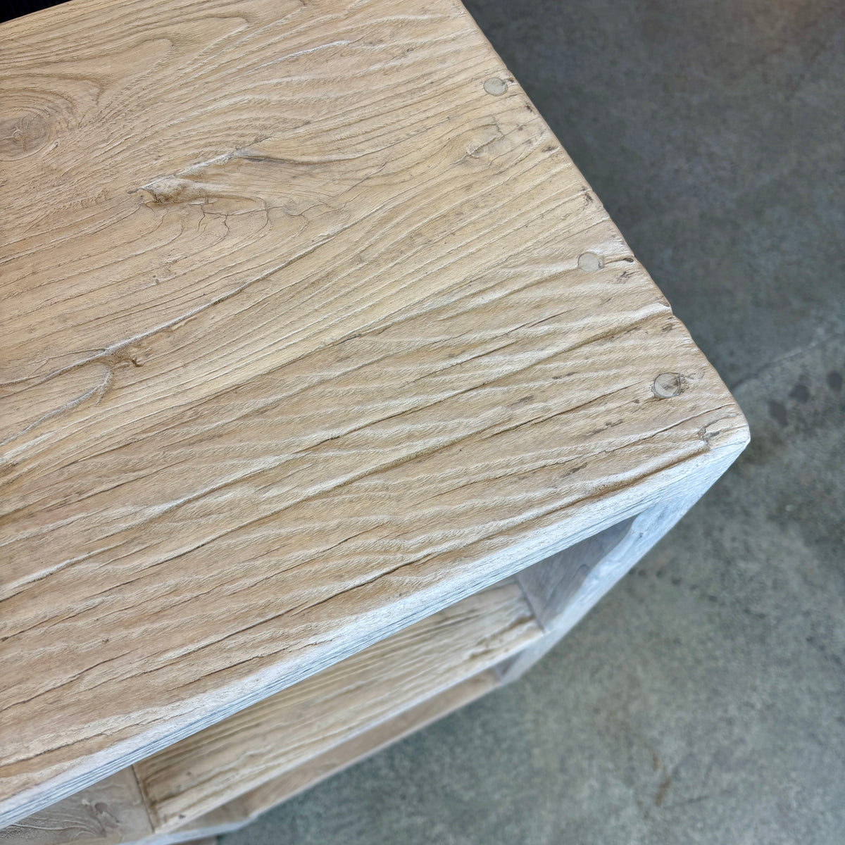 Close-up of a wooden surface with visible grain and texture.