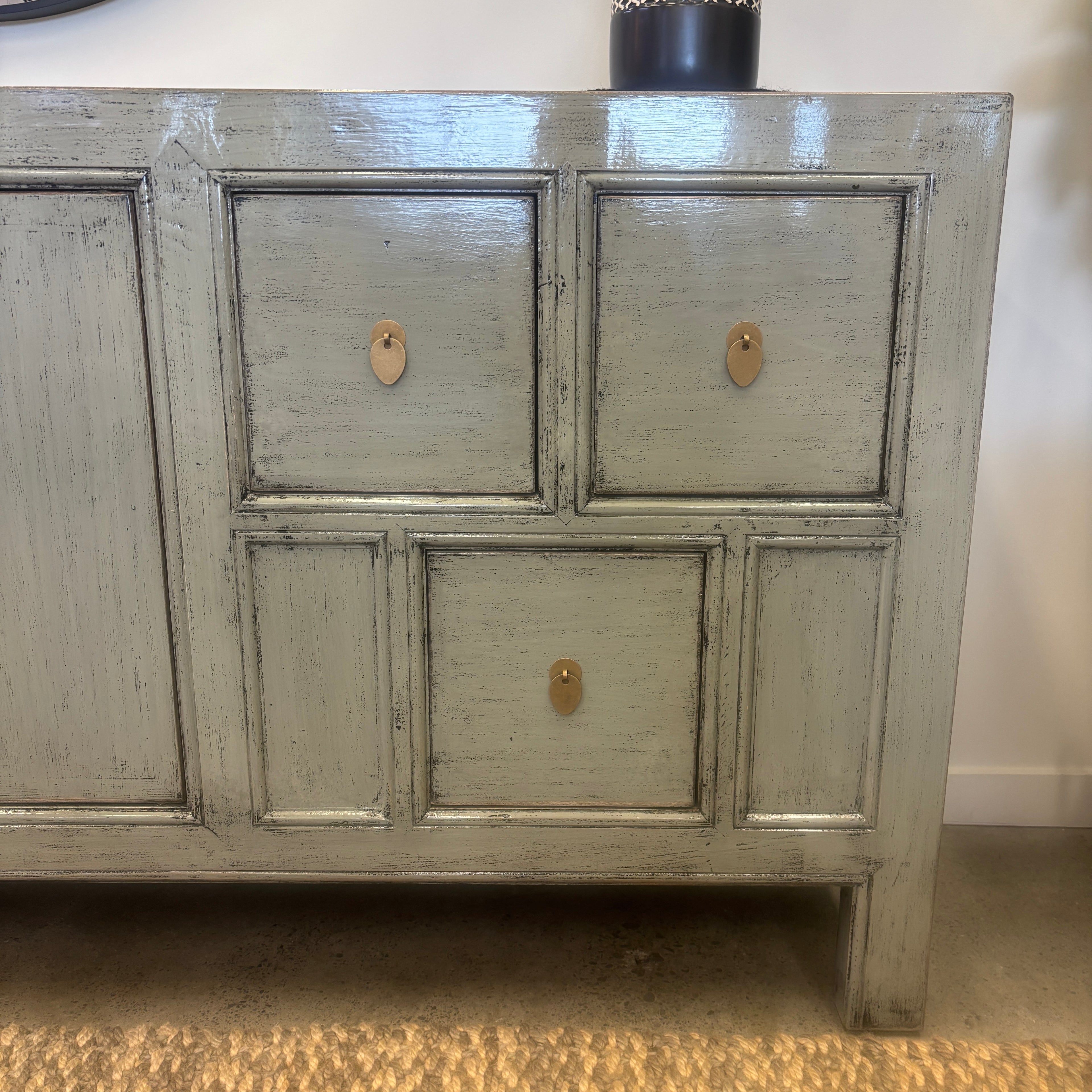Close-up of drawers and brass-toned handles on the Morocco Sideboard in glossy grey