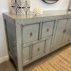 Angled view of Morocco Sideboard showing its long grey cabinet design, drawers and cupboard doors