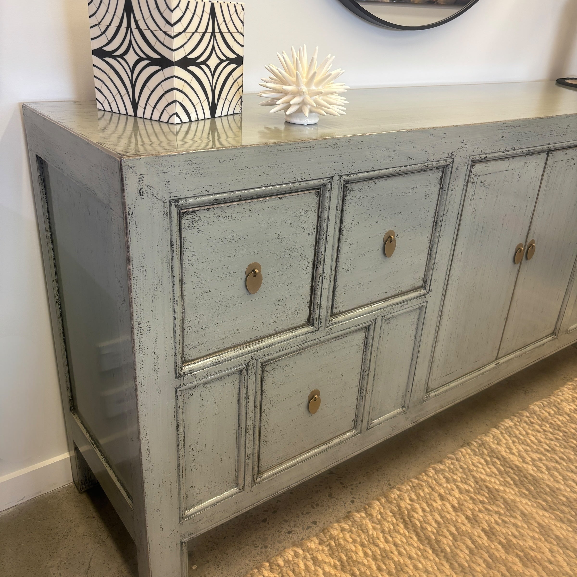 Angled view of Morocco Sideboard showing its long grey cabinet design, drawers and cupboard doors