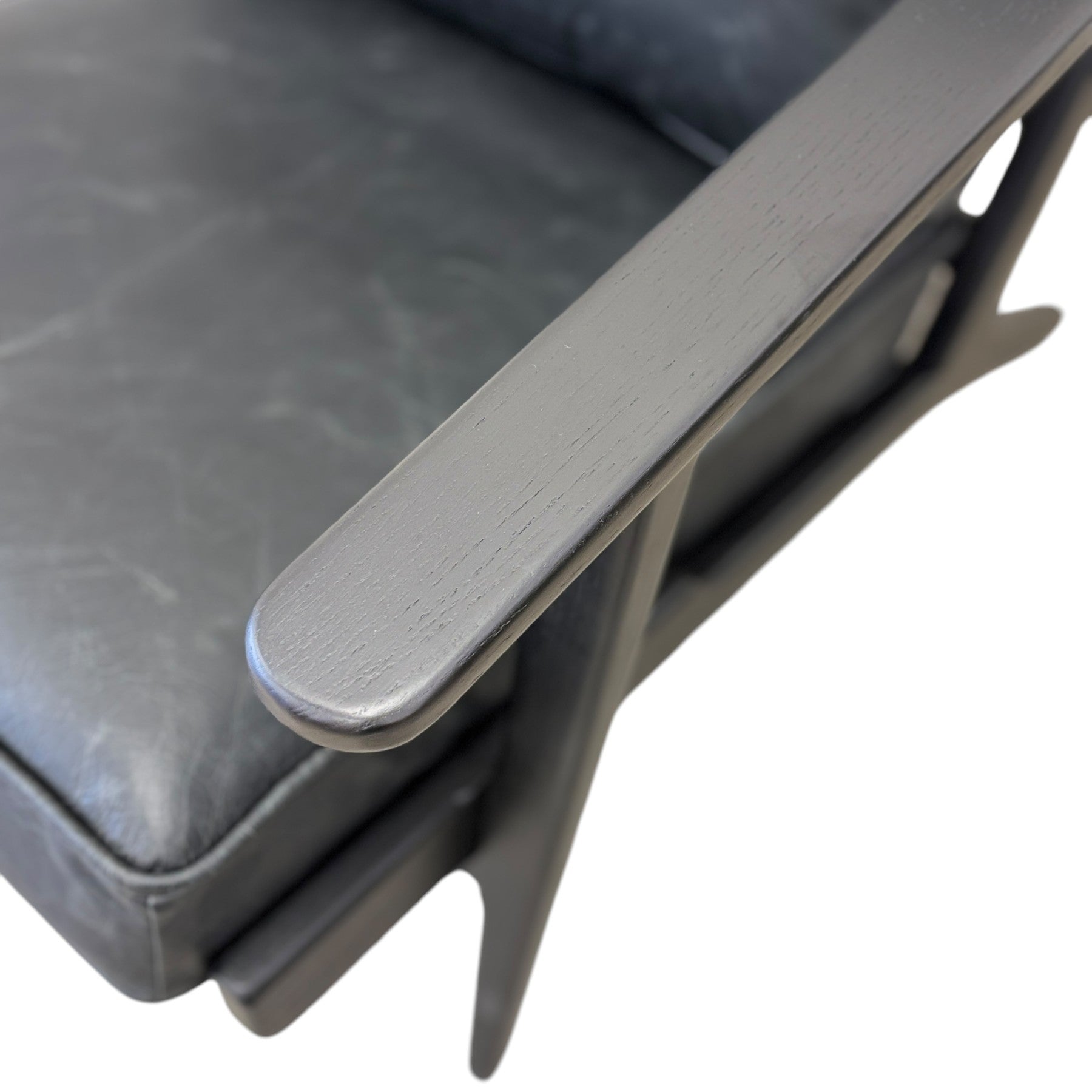 Overhead view of the Nero armchair in black leather, showing the generously padded seat and black frame.