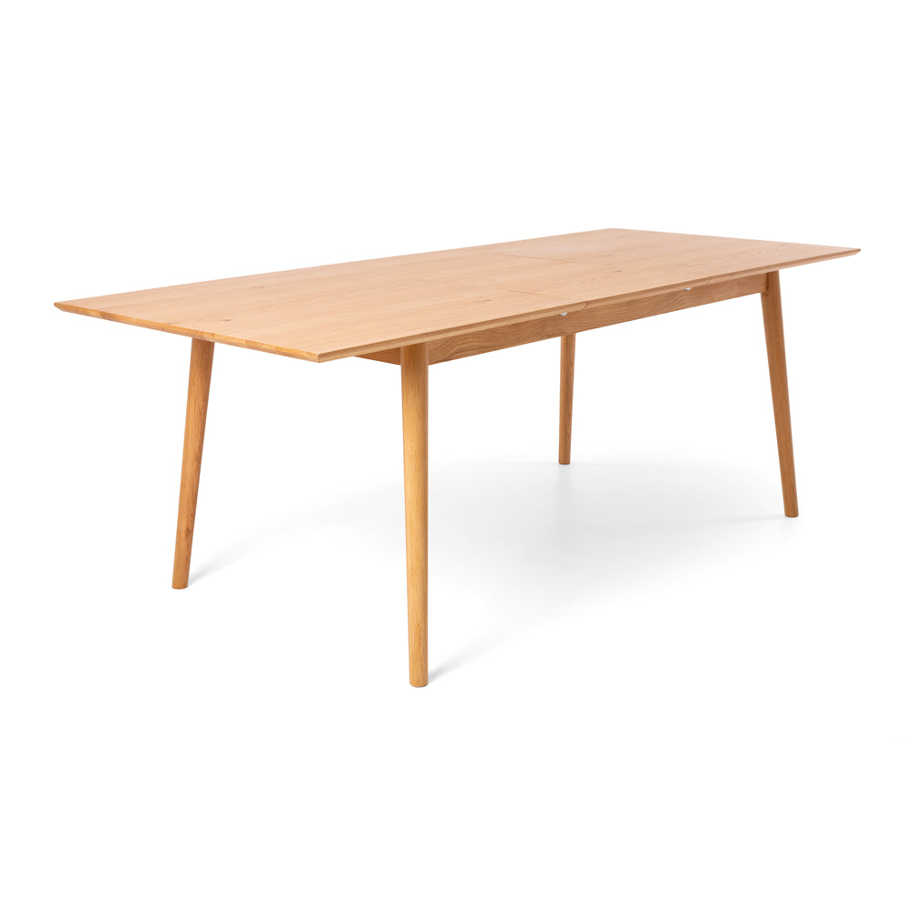 Nordik Extension Dining Table extended from 1.6m to 2.1m, showcasing the solid oak top, tapered legs and Scandinavian-inspired design.