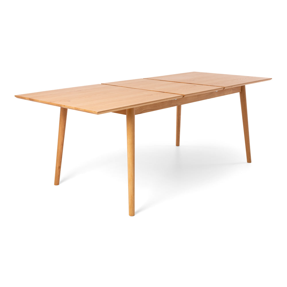 Nordik Extension Dining Table opened to accommodate the extension leaf, showing the practical extending mechanism and Scandinavian styling.