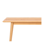 Side detail of the Nordik Extension Dining Table, showcasing the slim tabletop profile, solid oak construction and tapered timber leg.