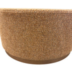 Nova Ottoman in copper textured fabric with a low round timber base