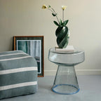 Odette Vase in glossy hunter green styled with delicate flowers on a glass side table