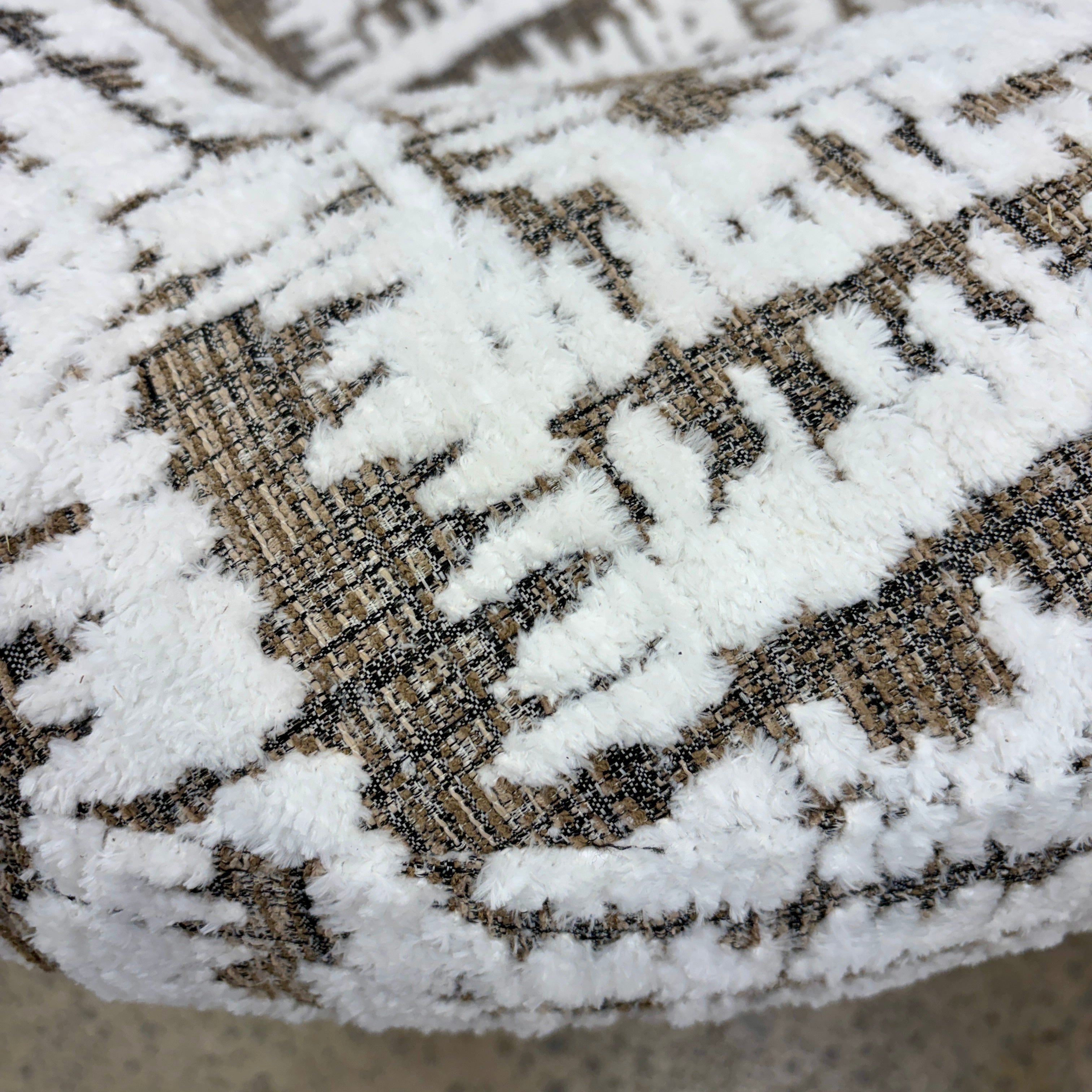 Close-up of the Patsy armchair's textured woven fabric upholstery.