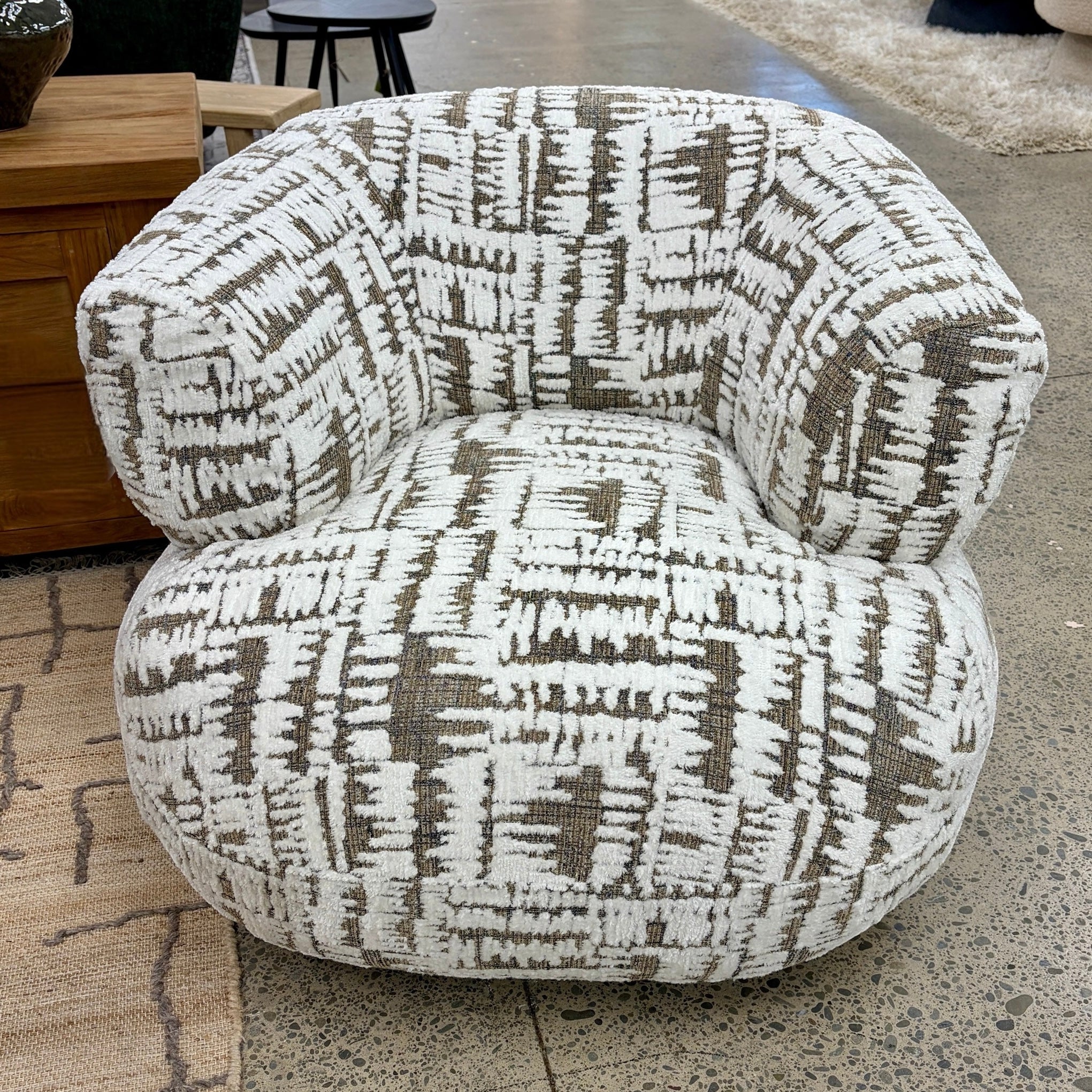Patsy armchair with contemporary design and soft fabric upholstery.