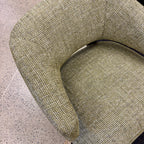 Angled view of the Pepper armchair, showcasing its comfortable seat and modern silhouette.