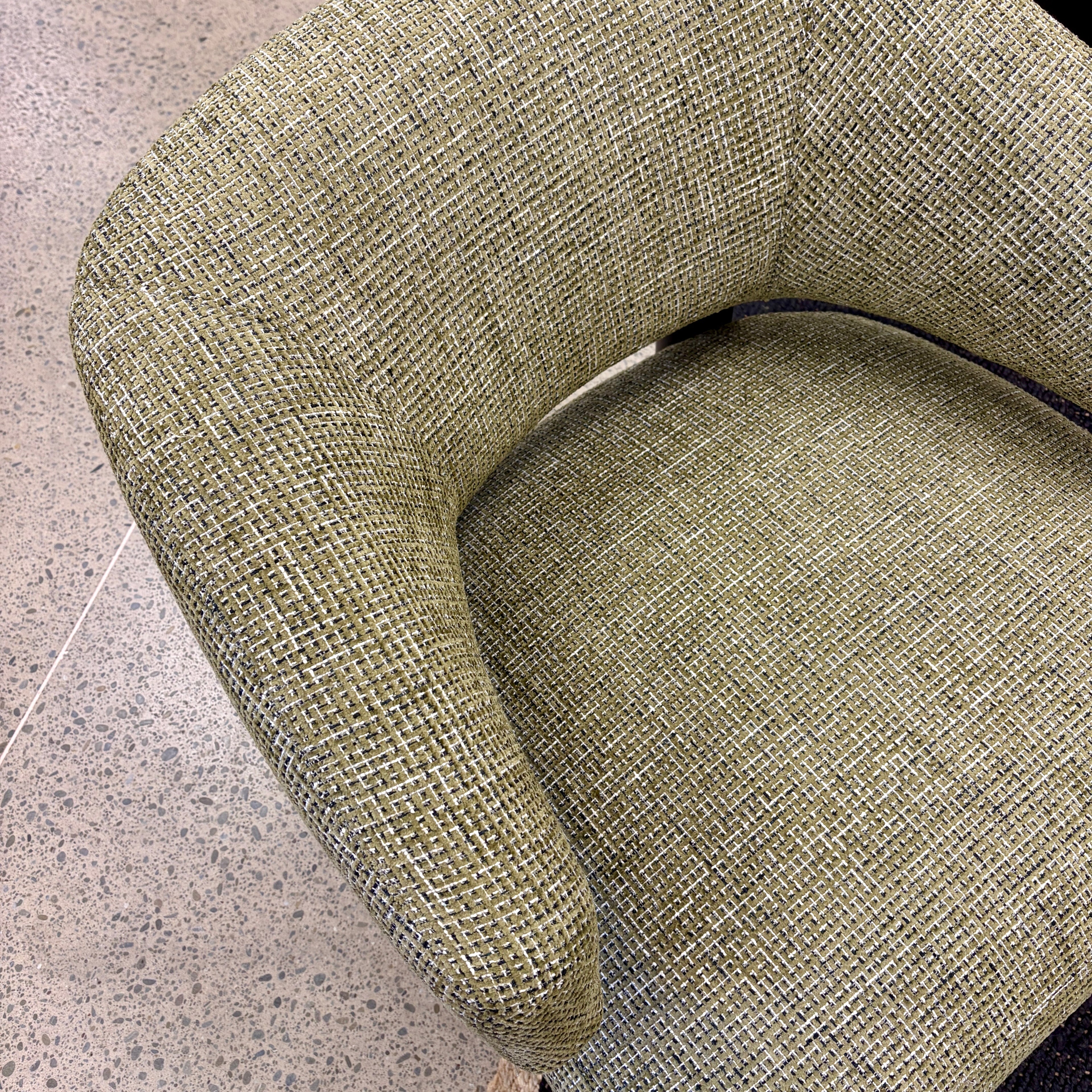 Angled view of the Pepper armchair, showcasing its comfortable seat and modern silhouette.