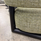 Close-up of the Pepper armchair, featuring textured fabric and quality craftsmanship.
