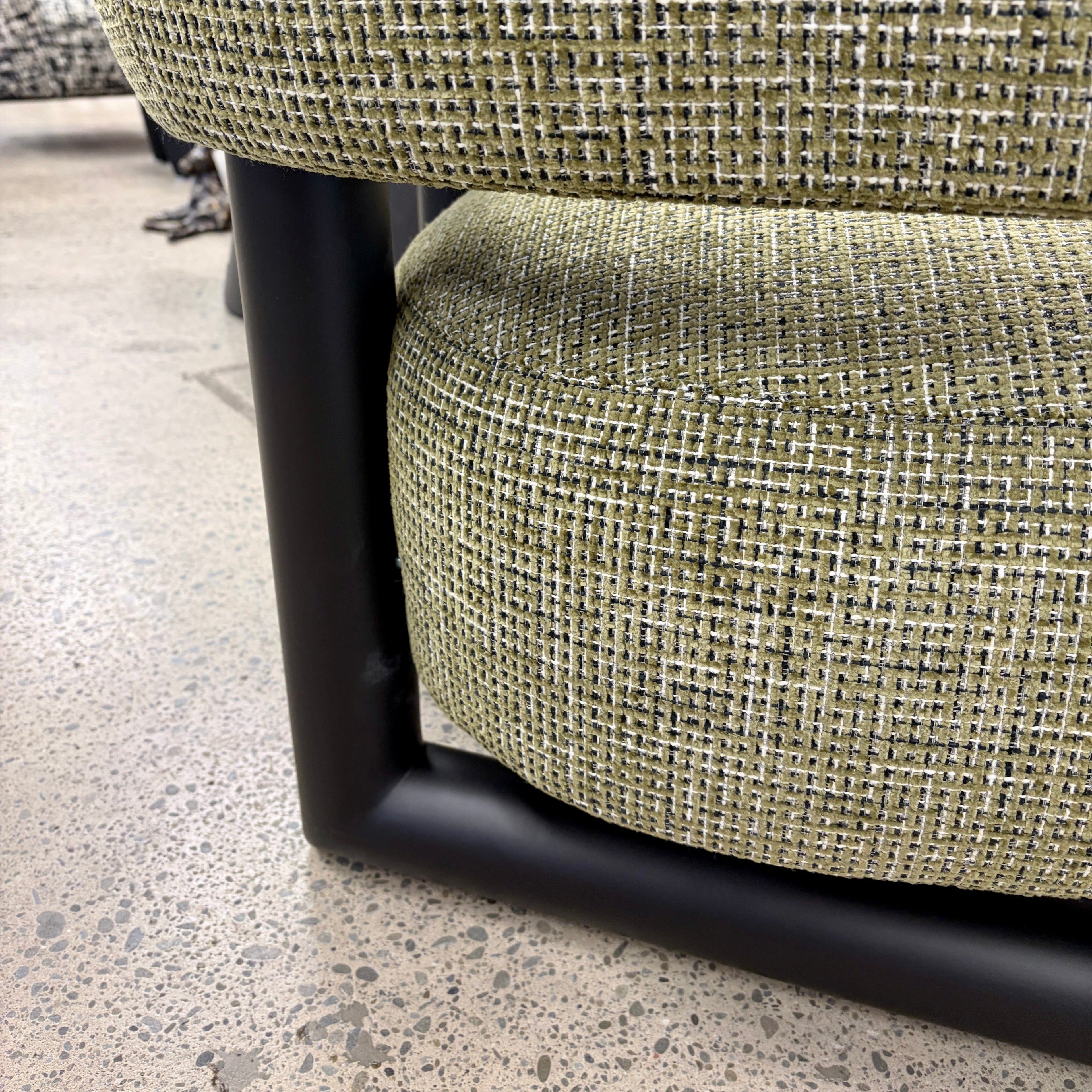 Close-up of the Pepper armchair, featuring textured fabric and quality craftsmanship.