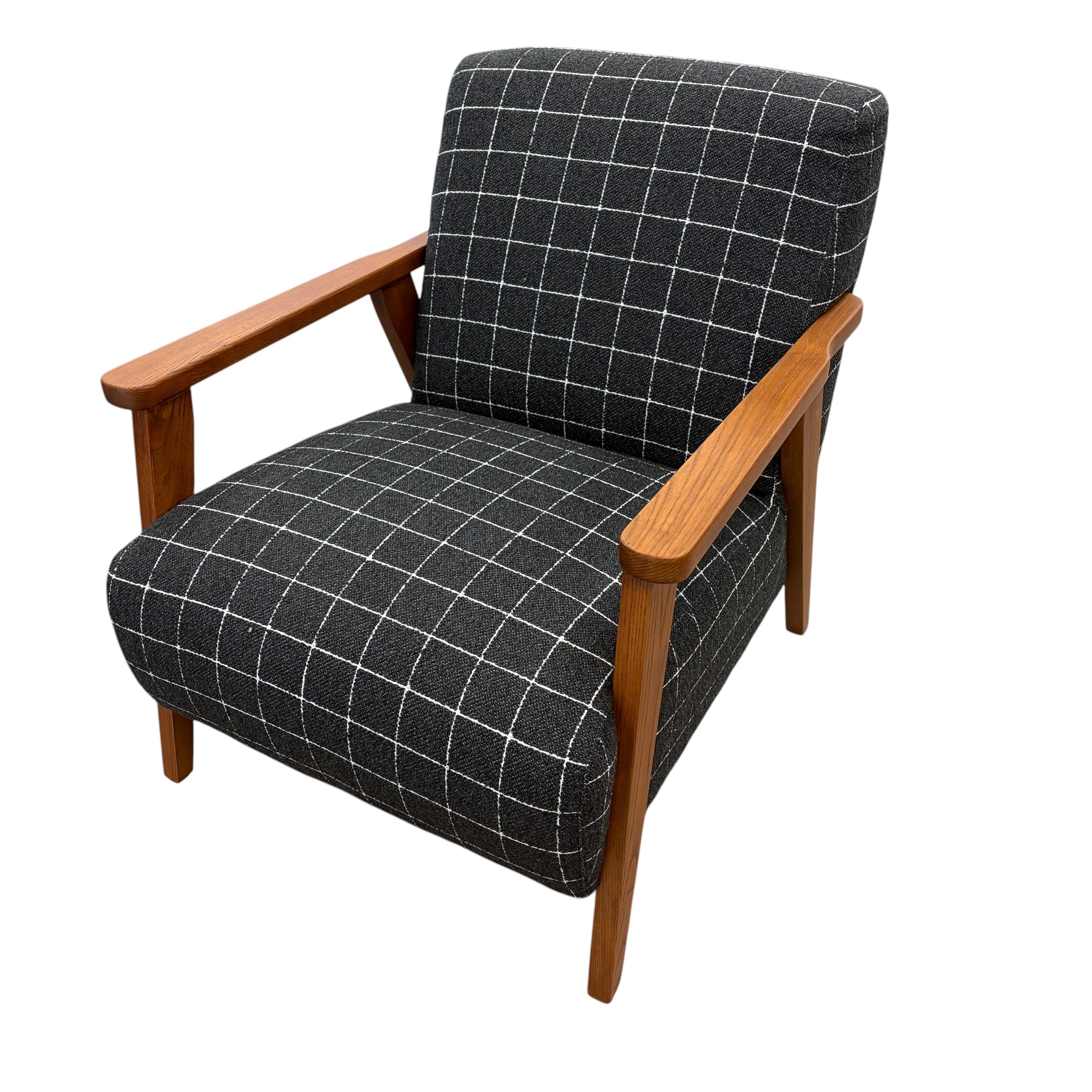 Angled view of the Pia Armchair showcasing its inviting proportions, rounded form and textured upholstery.