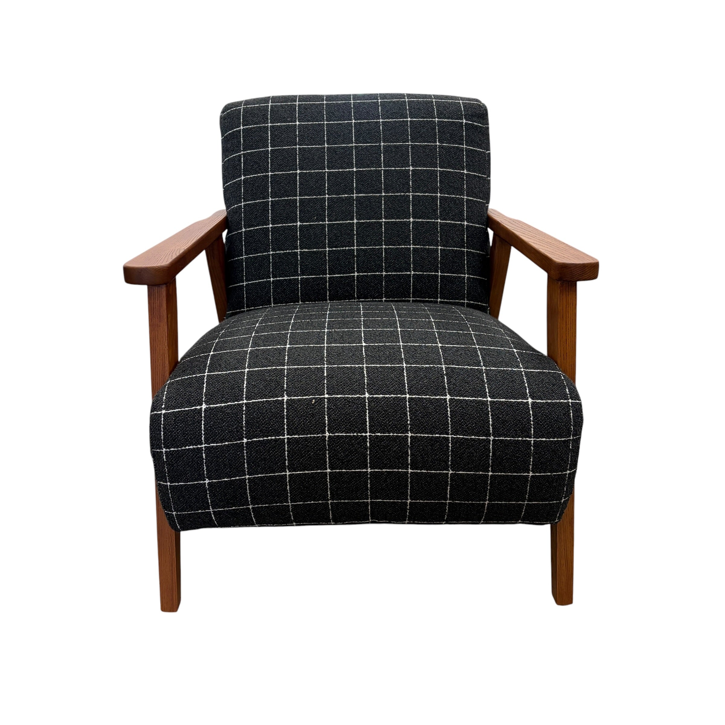 Pia Armchair featuring a generously proportioned seat, soft curved silhouette and textured fabric upholstery.