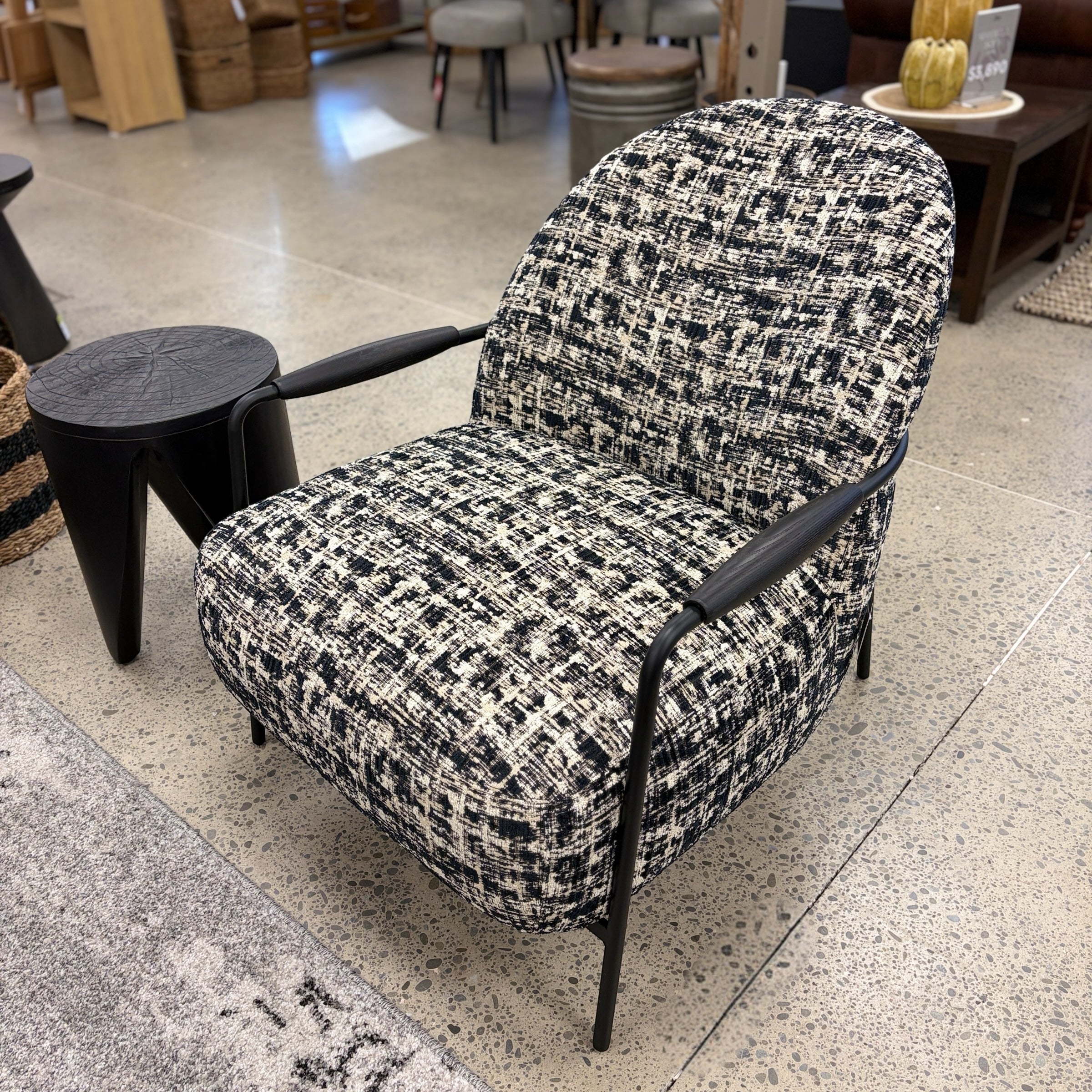 Angled view of the Portia armchair, showcasing its sculptural silhouette and soft upholstery.