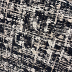 Detail of the Portia armchair's premium black and white woven fabric.