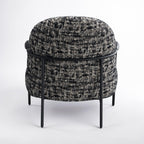 Rear view of the Portia armchair, highlighting its rounded shape and quality upholstery.