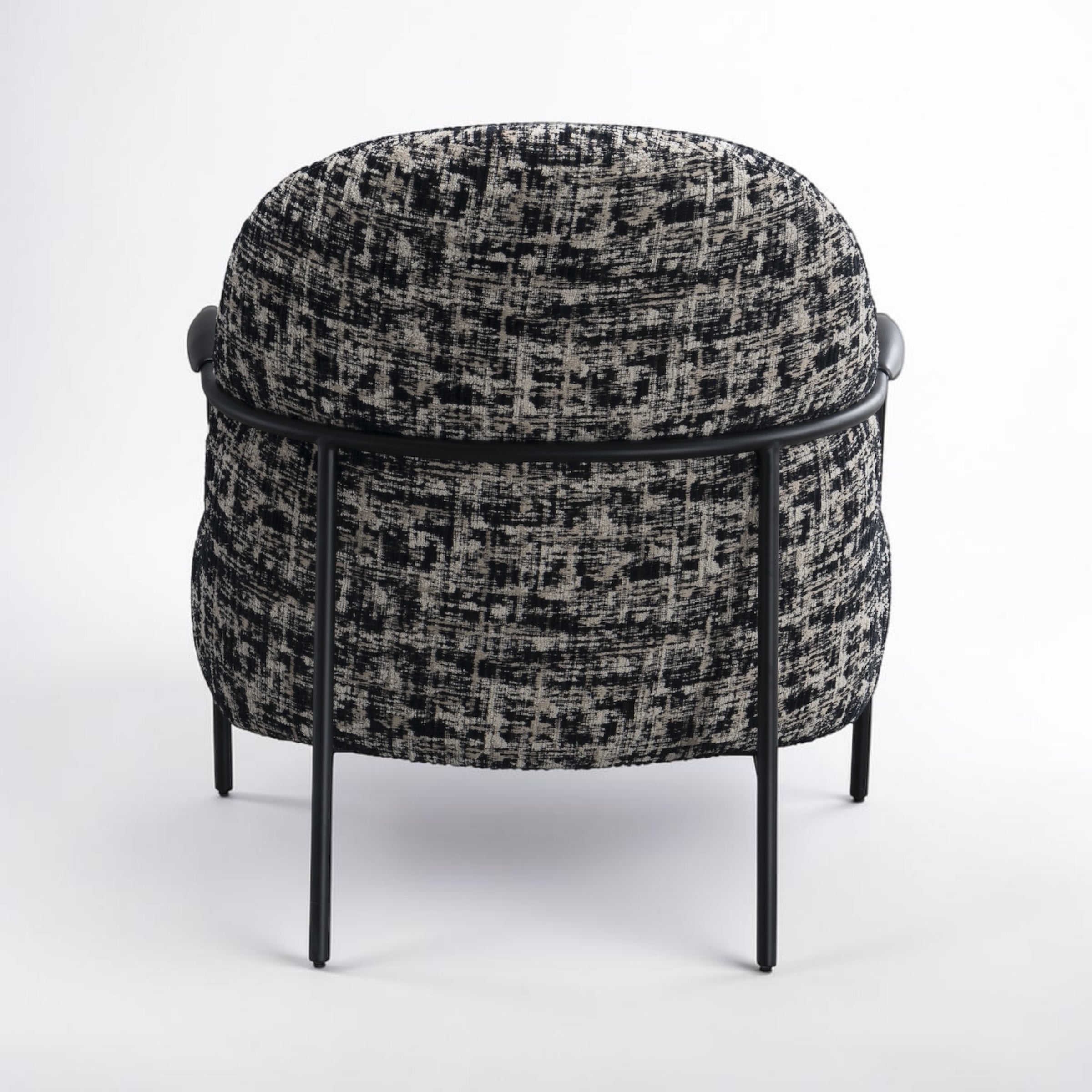 Rear view of the Portia armchair, highlighting its rounded shape and quality upholstery.