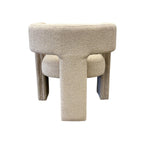 Rear view of the Reyna Chair in Bone, highlighting its fully upholstered curved back and architectural design.