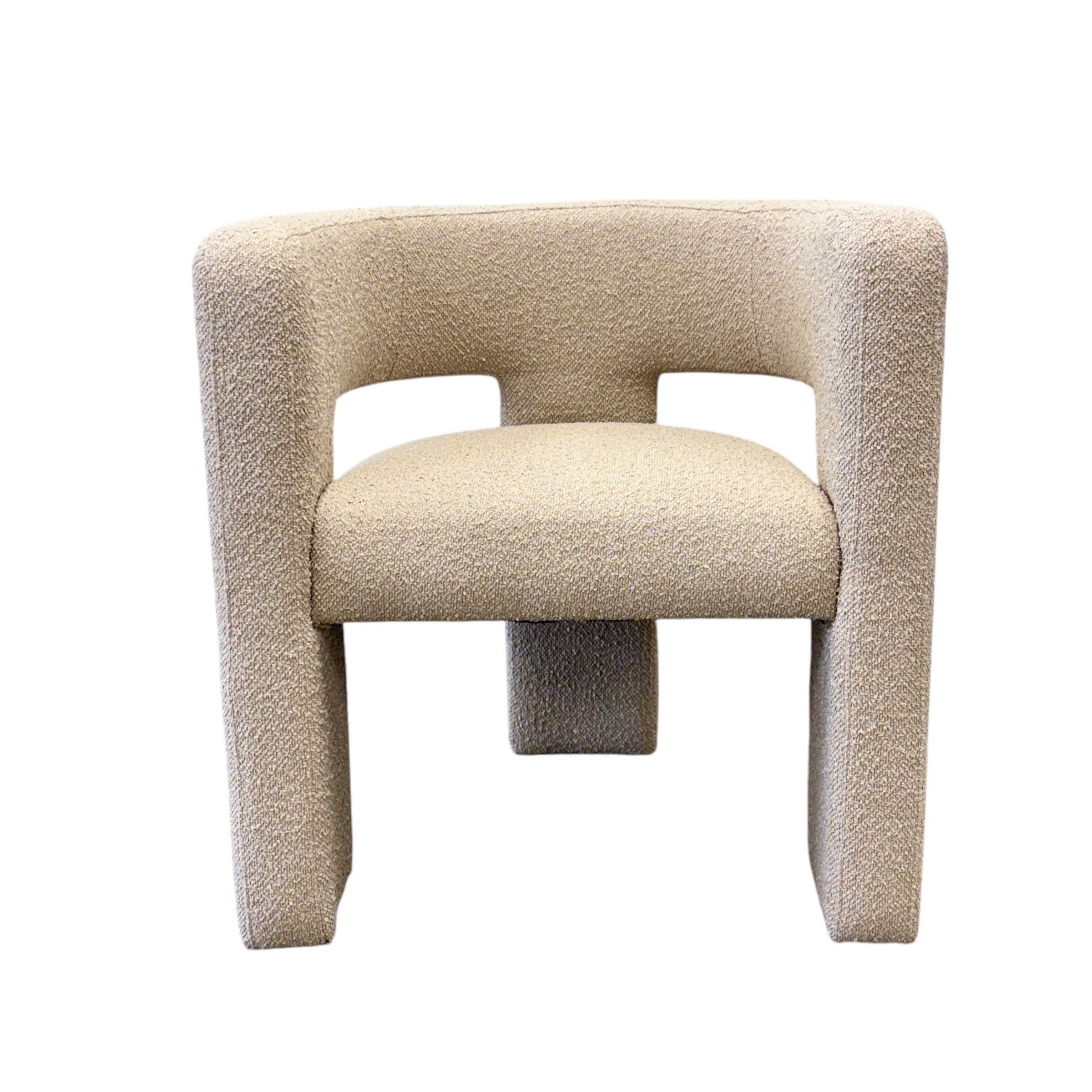 Reyna Chair in Bone with an architectural curved silhouette, textured upholstery and sculptural wraparound arms.Reyna Chair - Bone
