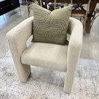 Reyna Chair in Bone styled in a contemporary living room, showcasing its sculptural silhouette and soft neutral upholstery.
