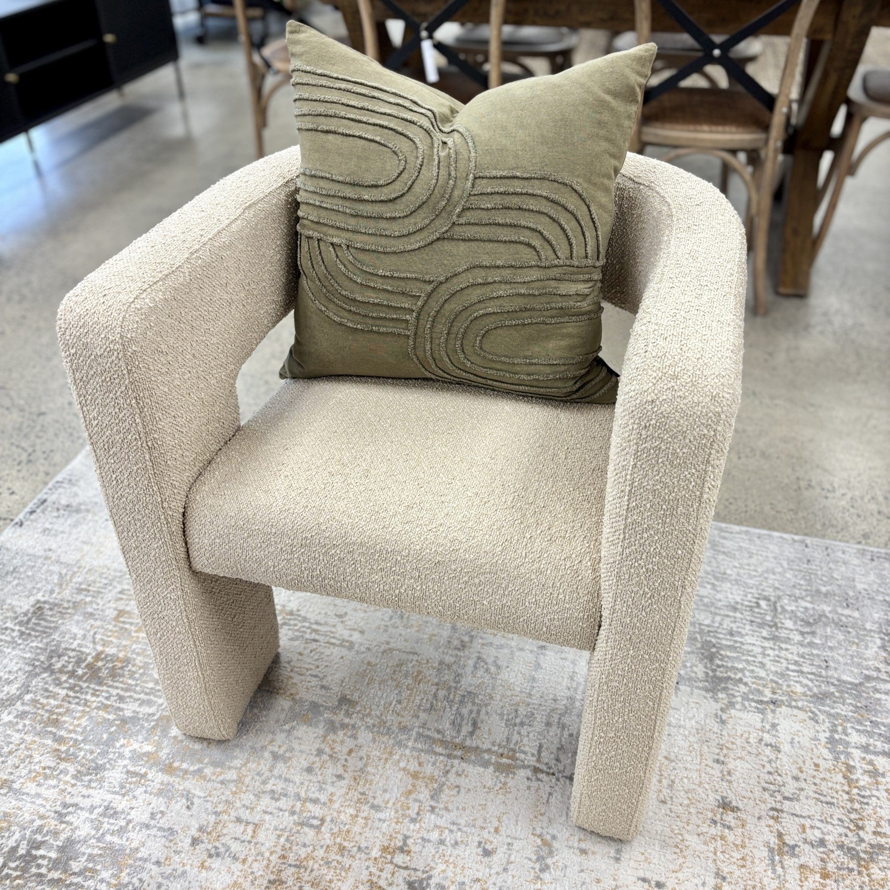 Reyna Chair in Bone styled in a contemporary living room, showcasing its sculptural silhouette and soft neutral upholstery.