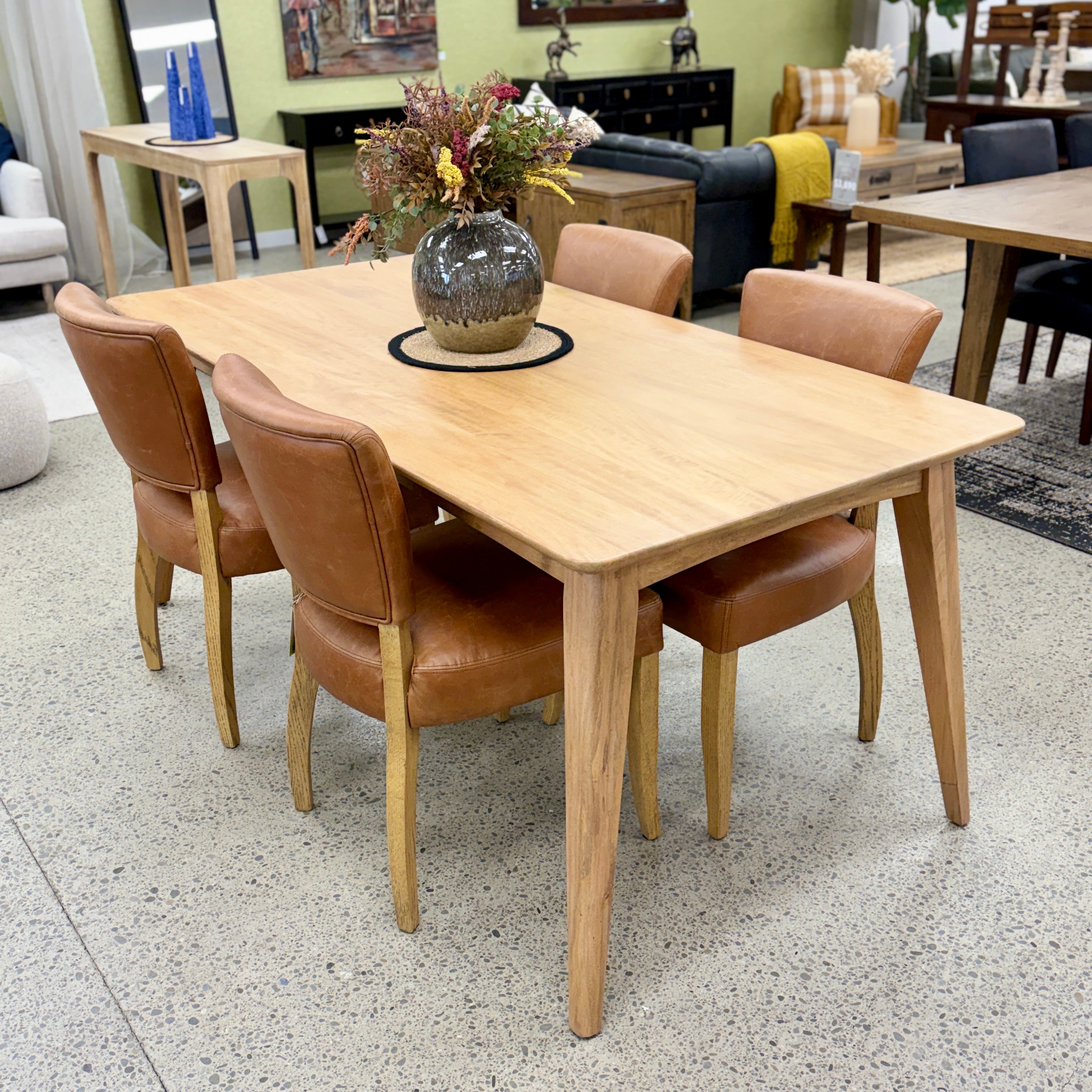 Rocco Dining Table in Natural styled with contemporary dining chairs, showcasing its solid mango wood construction and warm timber finish.