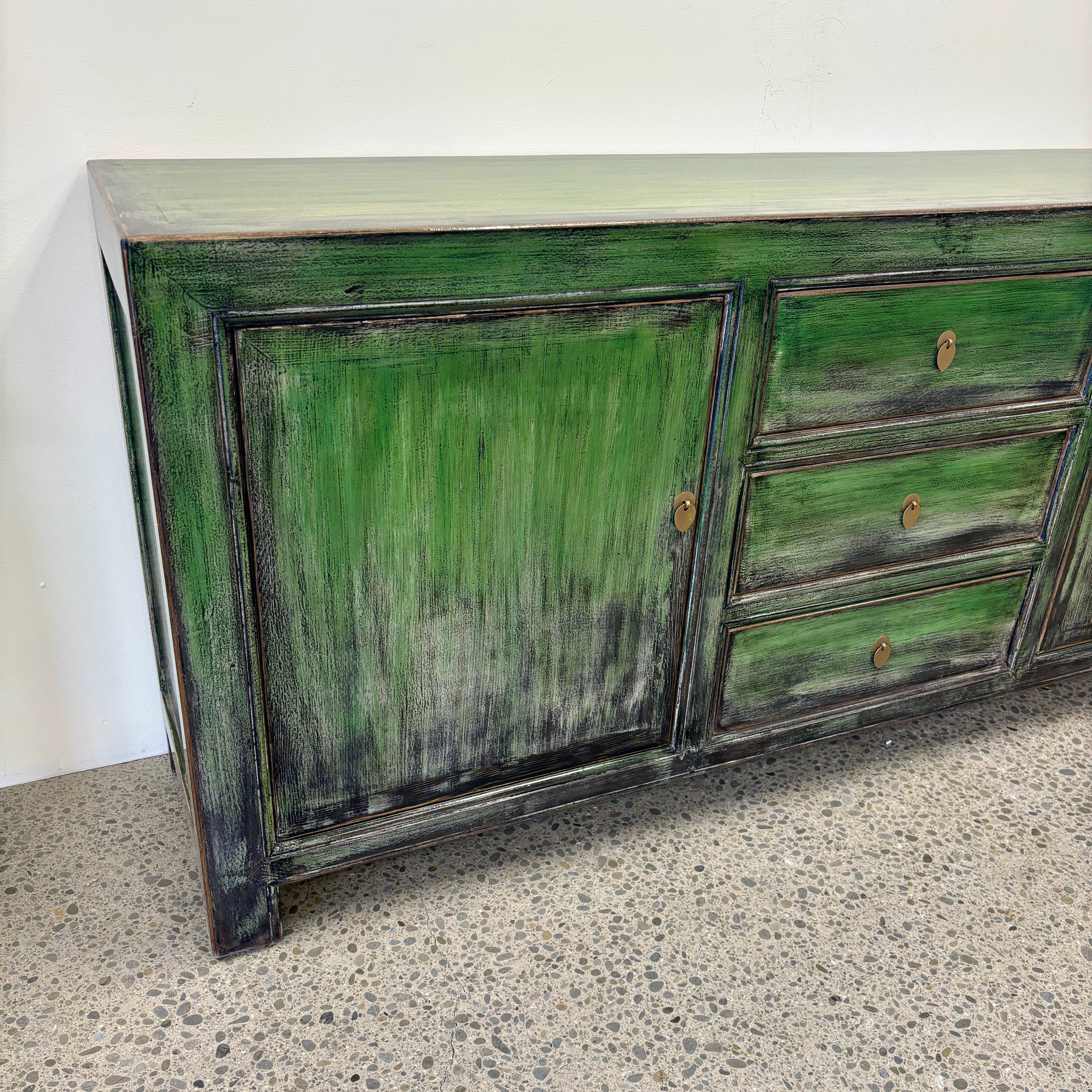 Angled view of Rosa Sideboard showing the textured distressed green and darkened finish