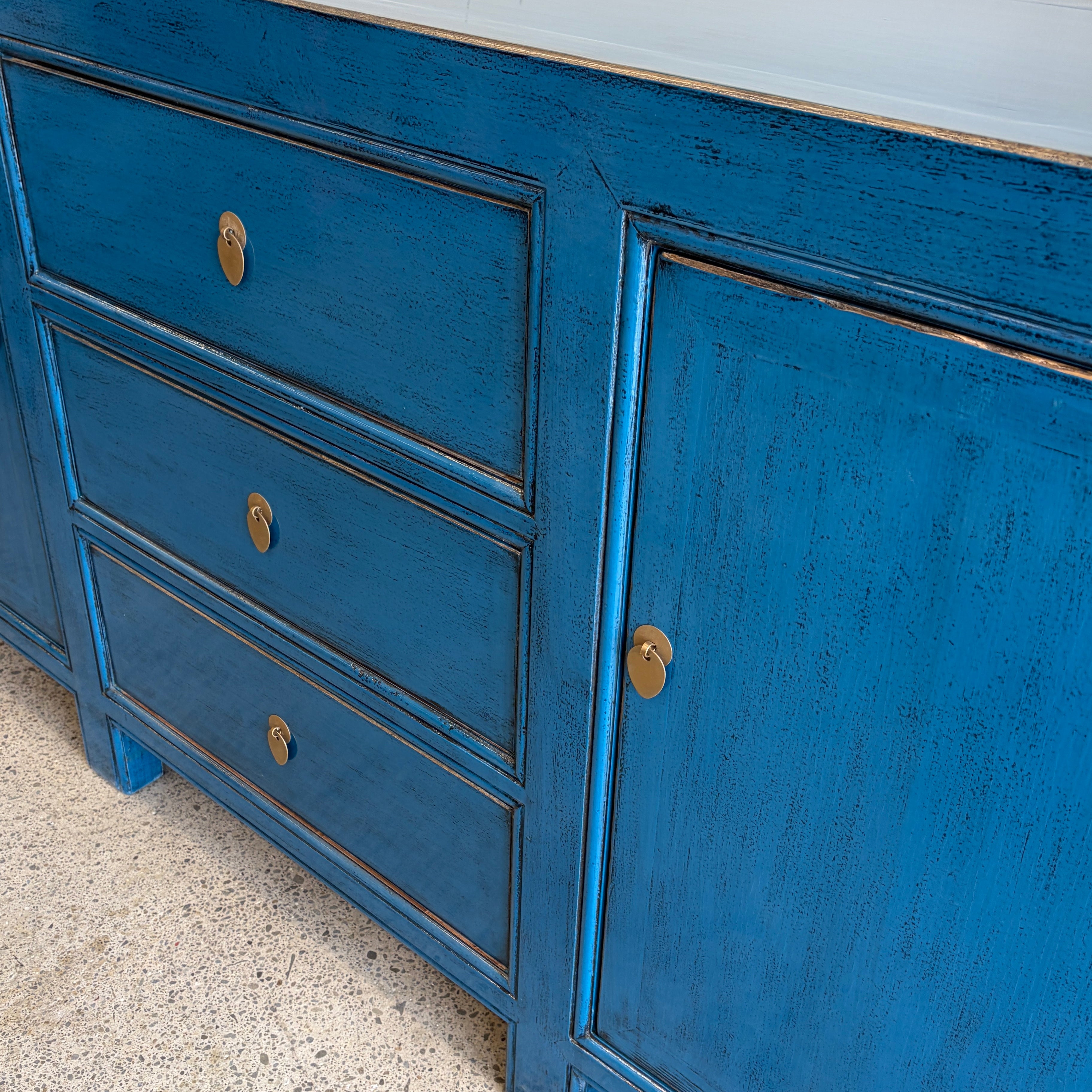 Right angled view of Rosa royal blue sideboard with drawers and cupboard storage