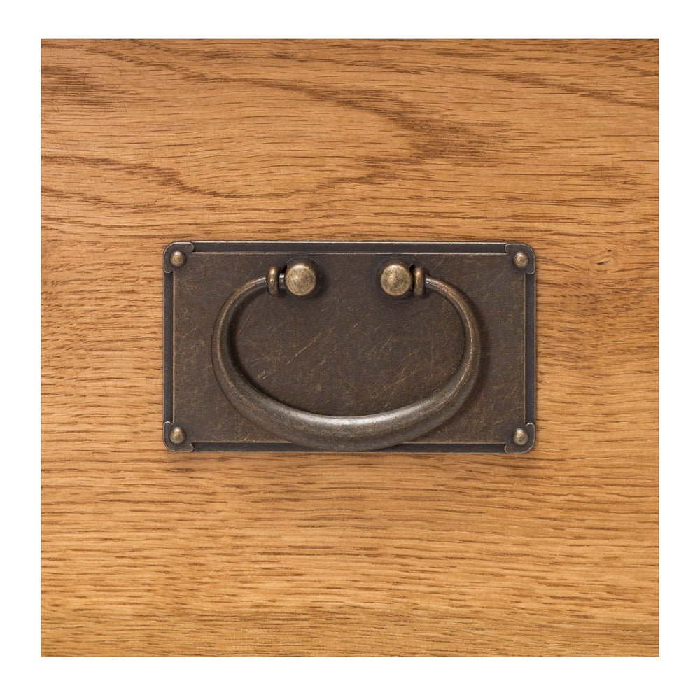 Close up of Salisbury Sideboard Small showing antique-style metal drawer handle and natural oak grain