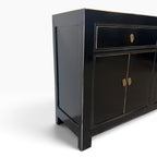 Angled view of Sara black sideboard with gold-toned detailing