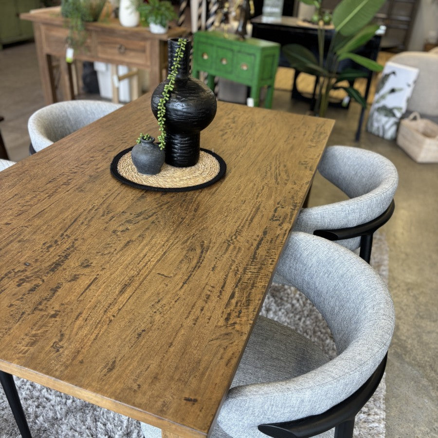 Sienna Dining Table in solid mango wood styled for a contemporary dining setting.