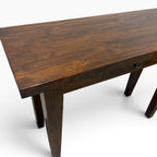 Angled view of solid teak console desk showing natural timber grain and spacious tabletop