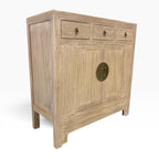 Angled view of the Sunny Sideboard in Natural Elm showing three drawers, double doors and panelled side