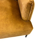 Close-up of the Sydney armchair's Gold woven fabric upholstery.