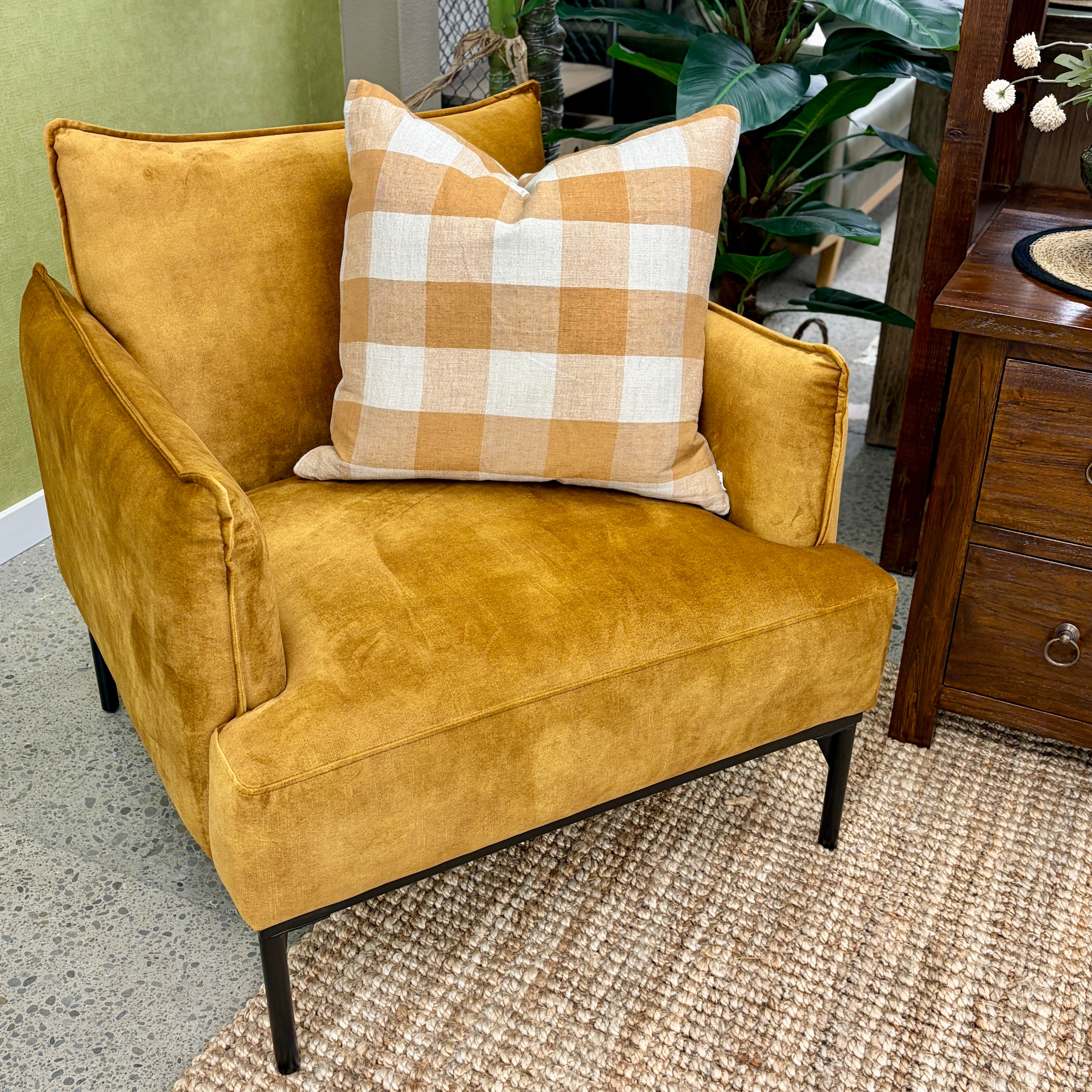 Sydney armchair in Gold styled in a contemporary living room with complementary furniture and décor.