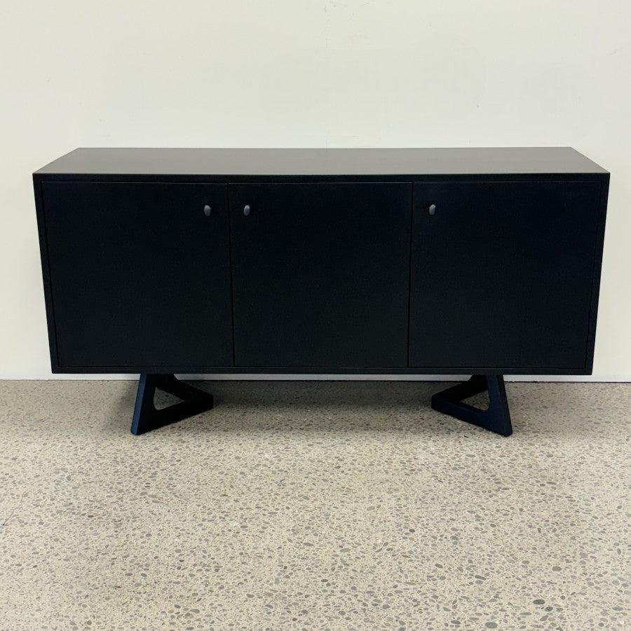 Tex Sideboard showing streamlined black finish, three doors and sculptural feature legs